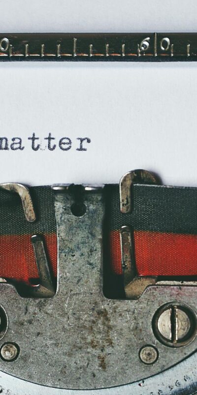 Close-up of a vintage typewriter with the text 'Stories matter' typed on paper, evoking nostalgia.